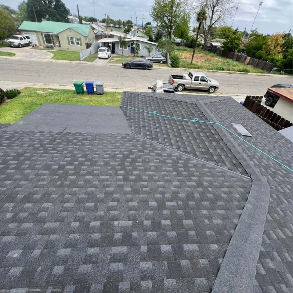 Newly shingled grey roof seen from above the ridge — Cristian House Remodeling LLC