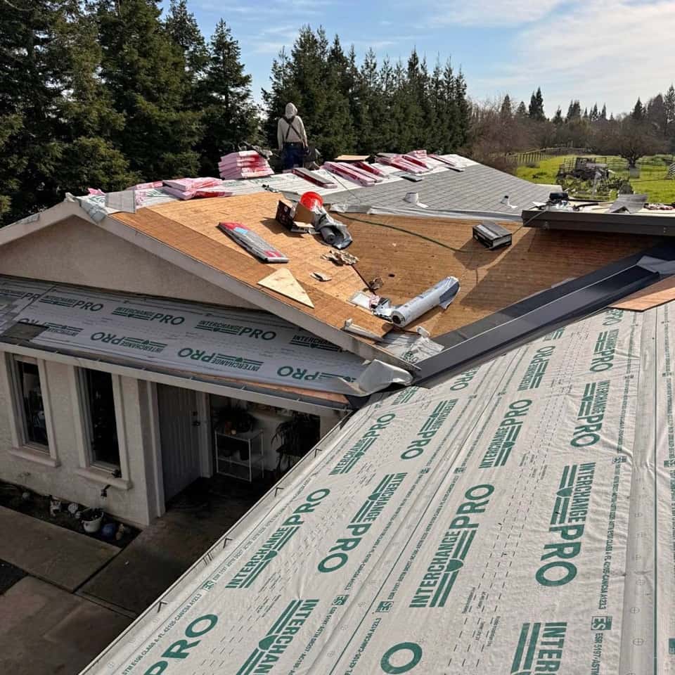 Roof with new underlayment and shingle bundles staged for installation — Cristian House Remodeling LLC