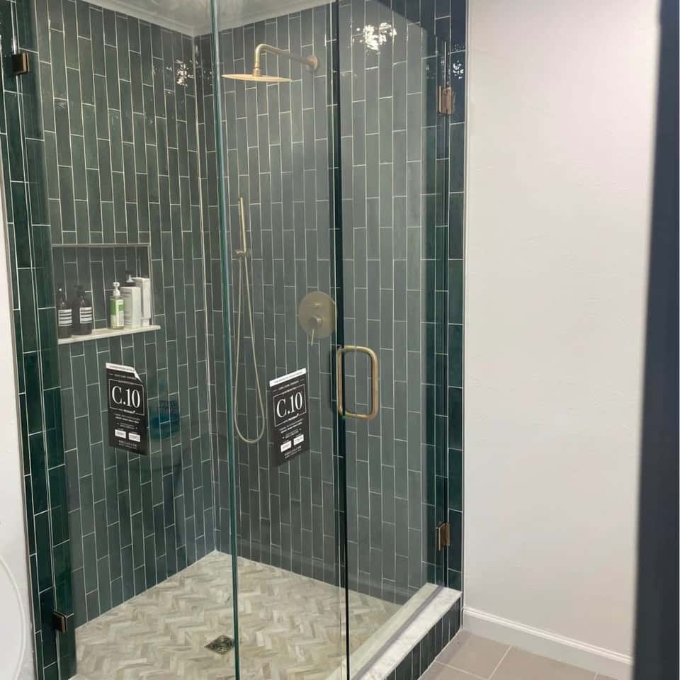 Finished shower with green tile and a glass door — Cristian House Remodeling LLC