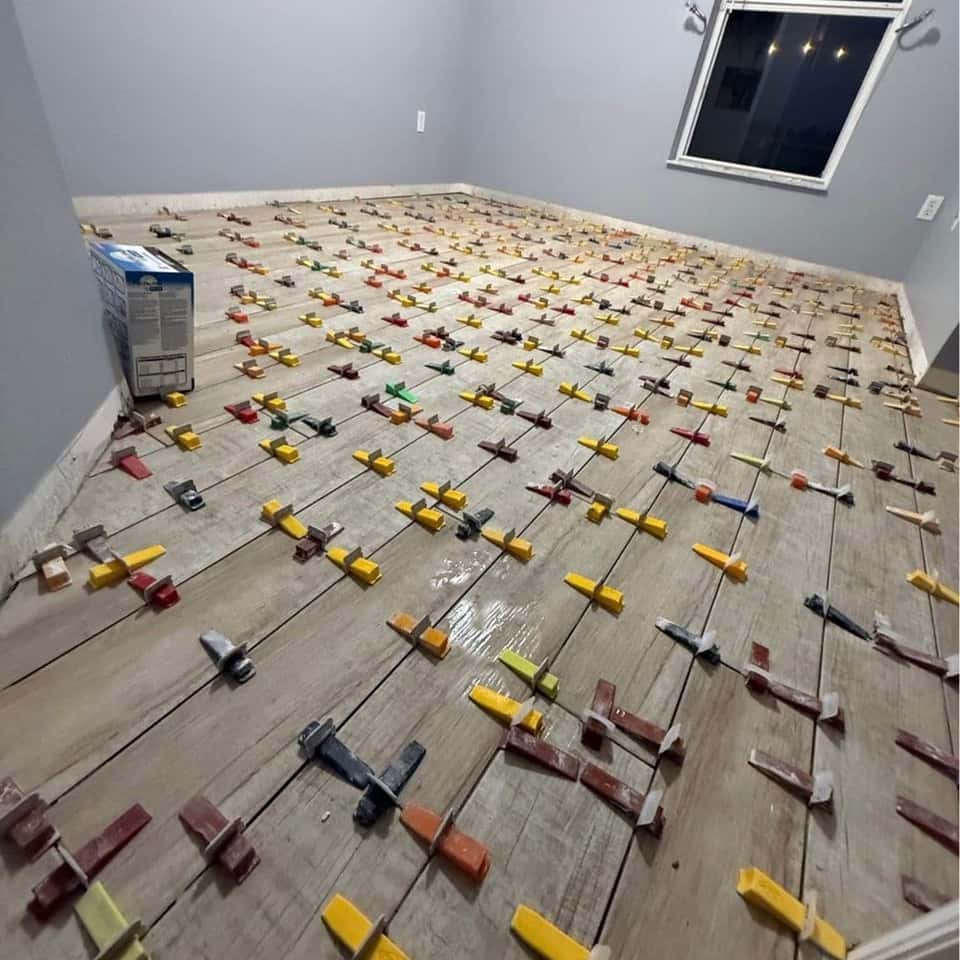 Plank tile floor with levelling clips in a bedroom — Cristian House Remodeling LLC