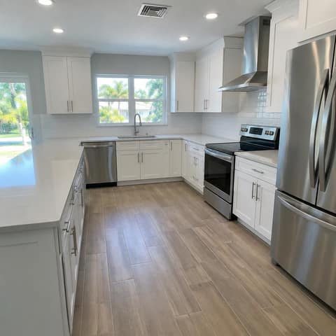 Remodeled kitchen with white shaker cabinets, quartz counters and stainless appliances — Cristian House Remodeling LLC