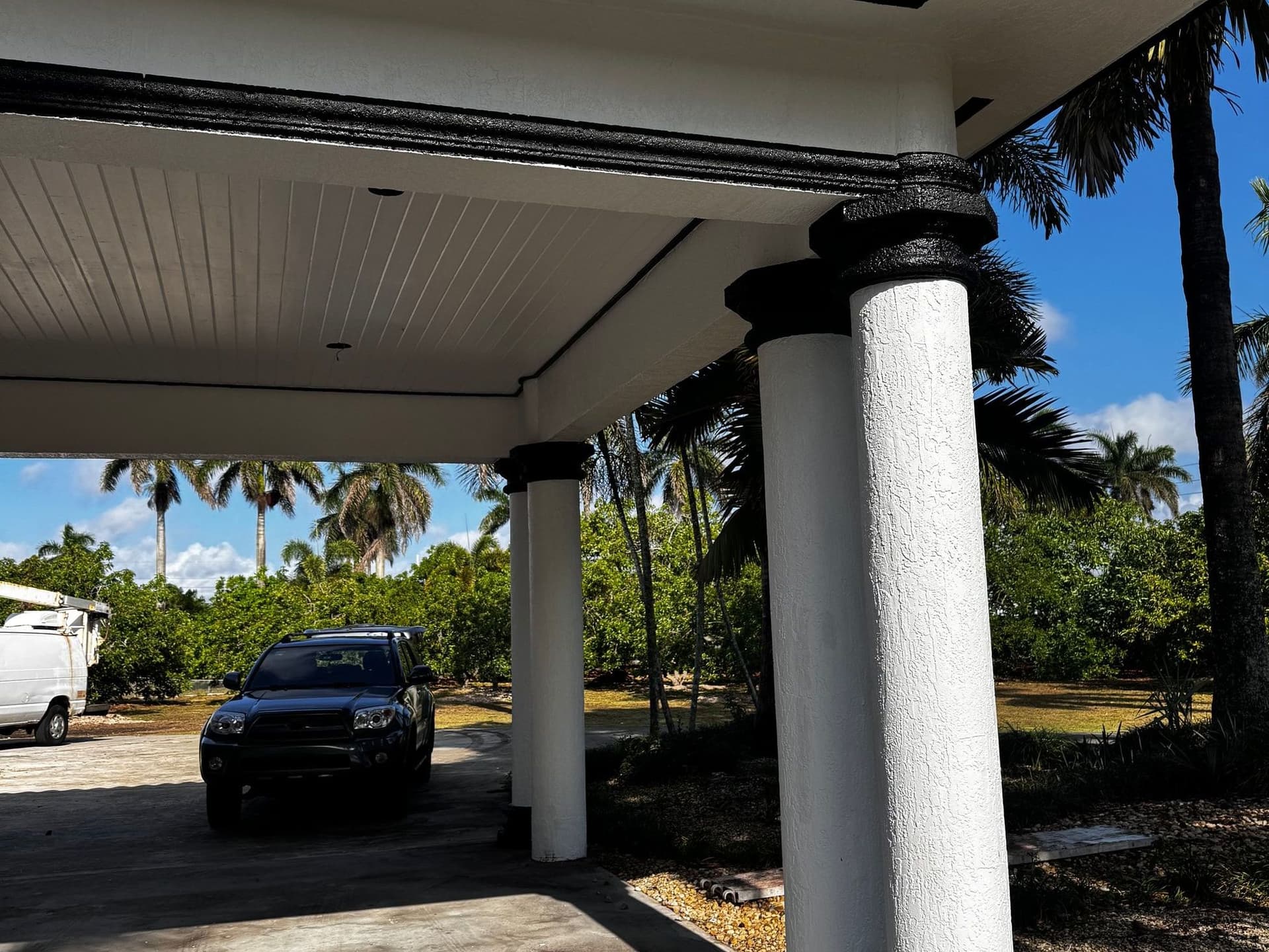 Freshly painted portico and stucco columns finished by Cristian House Remodeling LLC